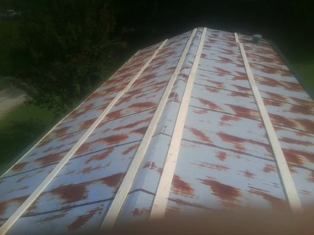Rusted metal roof panels with new wood purlins before replacement — Storm Damage Roof Repair in Chugwater by Roofing Brothers
