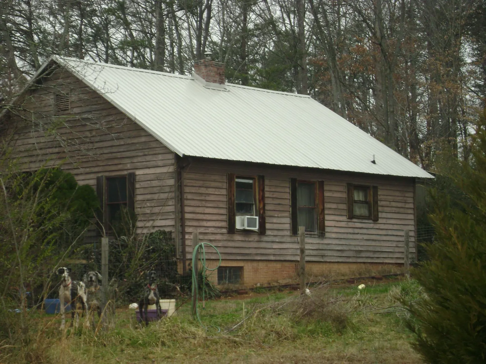 White metal roof on an old wood sided farmhouse, from a Metal Roof Installation job in Chugwater